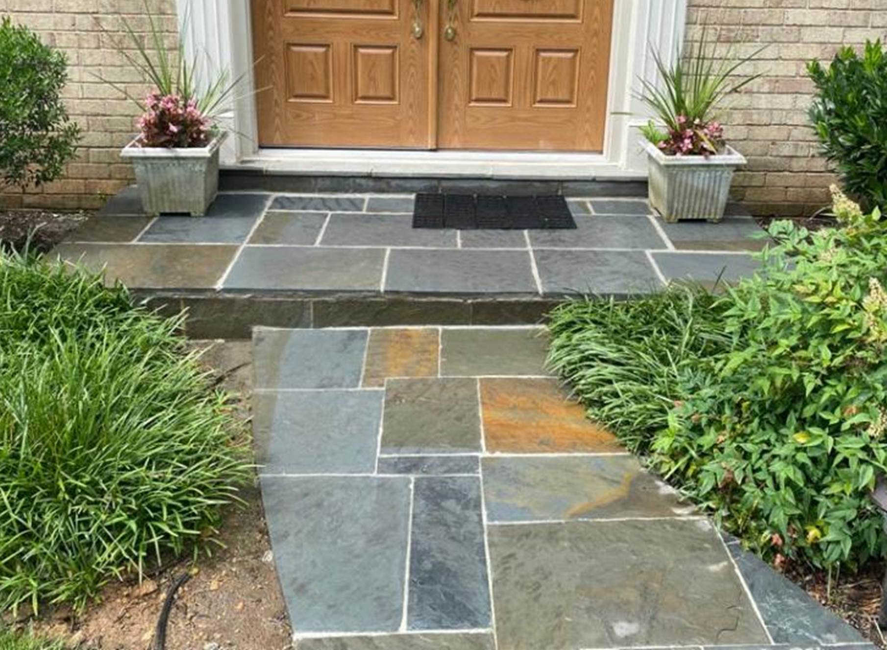 A picture containing outdoor, building, stone, porch

Description automatically generated