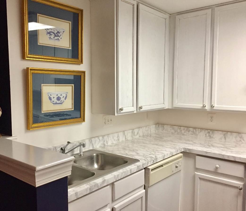 A kitchen with white cabinets

Description automatically generated with medium confidence
