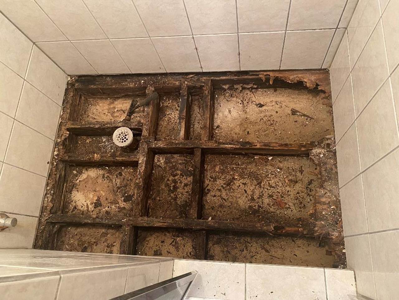 A picture containing wall, indoor, dirty, tiled

Description automatically generated